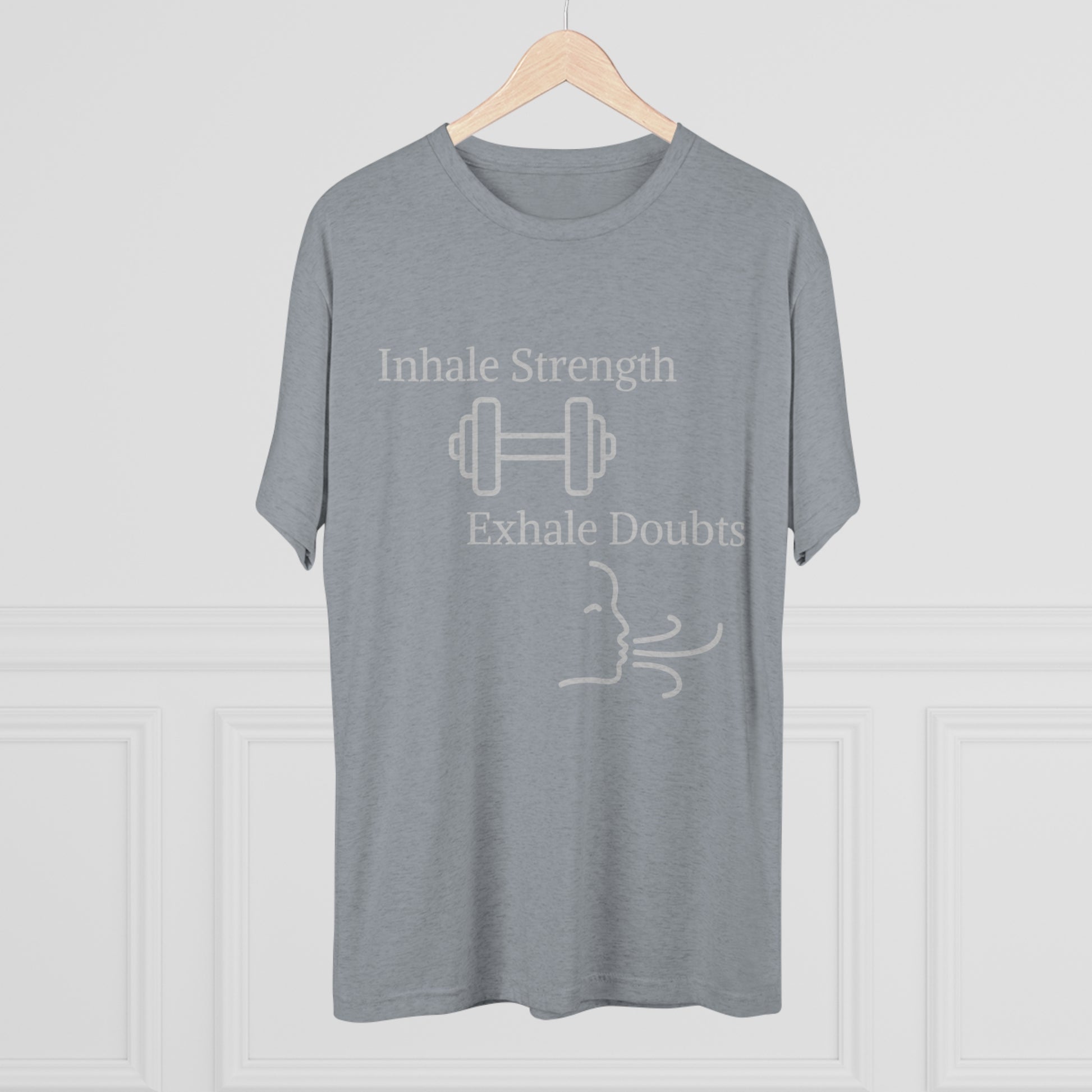 Printify's Inhale Strength Exhale Doubt w Images - Unisex Tri-Blend Crew Tee on a hanger features the text "inhale strength exhale doubts" with a dumbbell icon and a stylized exhaling face, against a neutral background.