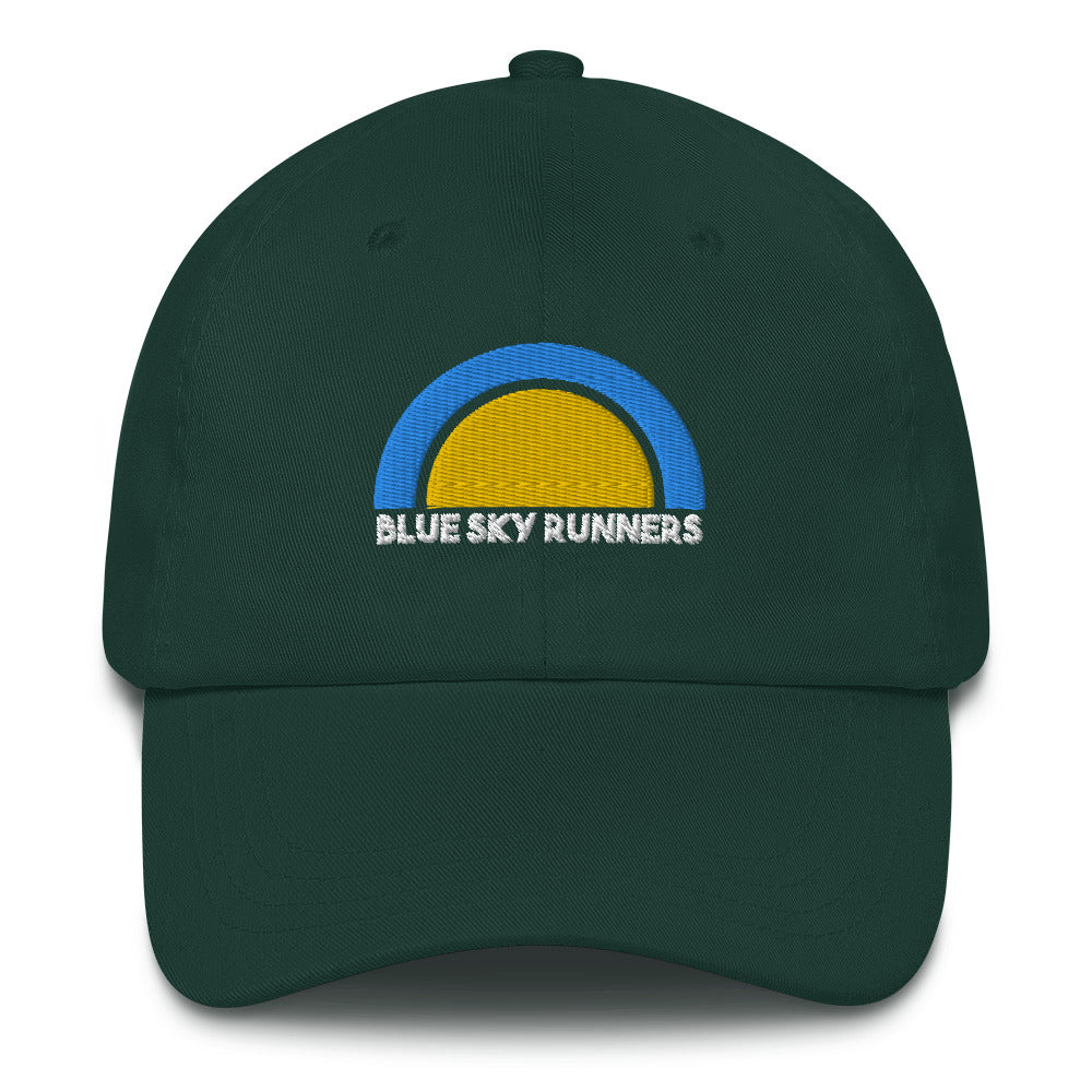 Introducing the Blue Sky Runners - Dad Hat by Blue Sky Runners. This dark green low profile cap features a semicircular logo with a blue outer arc and a yellow inner circle, symbolizing the sun. "BLUE SKY RUNNERS" is embroidered in white beneath the logo, while the cap itself boasts a curved brim and an adjustable strap at the back for perfect fit.